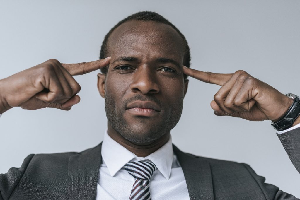 man pointing at forehead